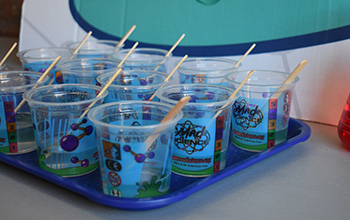 Mad science branded cups with popsicle sticks inside