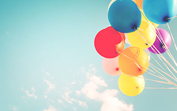 Colorful balloons in the sky ties to ribbons
